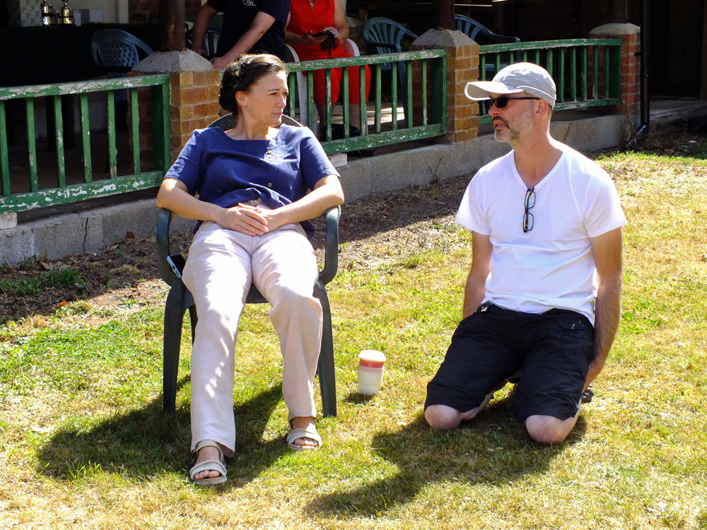 Photograph shows Natasha Minikin (pictured left) and Alan Williams (pictured right) relaxing in the sunshine after a testing morning's shooting.