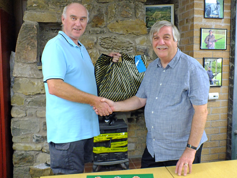 Photograph shows Osborn J Spence - SSRA Airgun Secretary - (pictured right) presenting the Staffordshire Combined Open Squadded Rifle Meeting - Class 'B' - 3rd Place Prize to Staffordshire .22 Prone Rifle shooter John Cooper of Leek and District Shooting Centre (pictured left).
