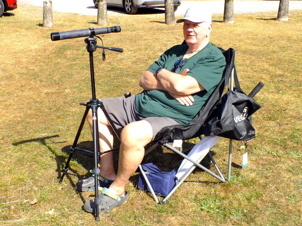 Photograph shows Lee Featherstone settling into position with his spotting scope before the final round of details begin.