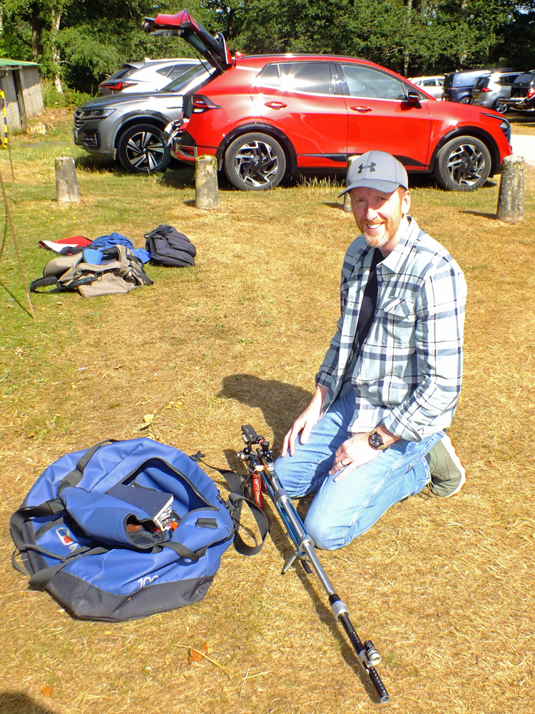 Photograph shows Simon Green prepping his kit in the glorious sunshine.