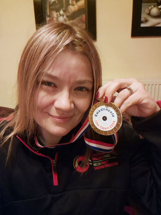 Photograph shows Steph Reynolds proudly displaying her medal.