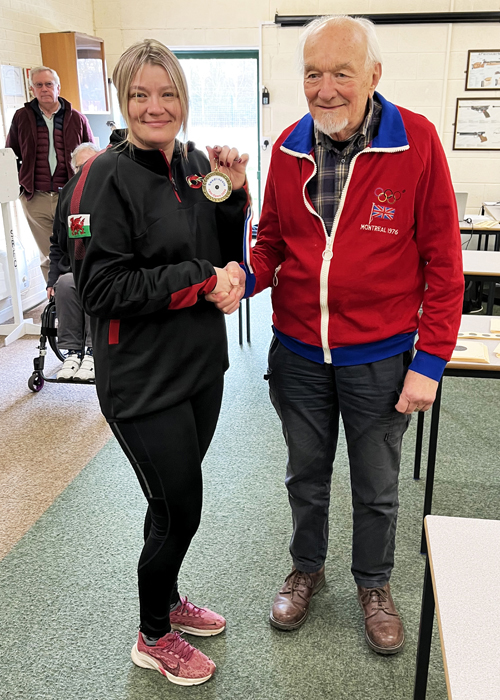 Photograph shows Steph Reynolds, pictured left, receiving the 10 Metres Air Rifle 1st Place Medal from Brian Girling, pictured right.