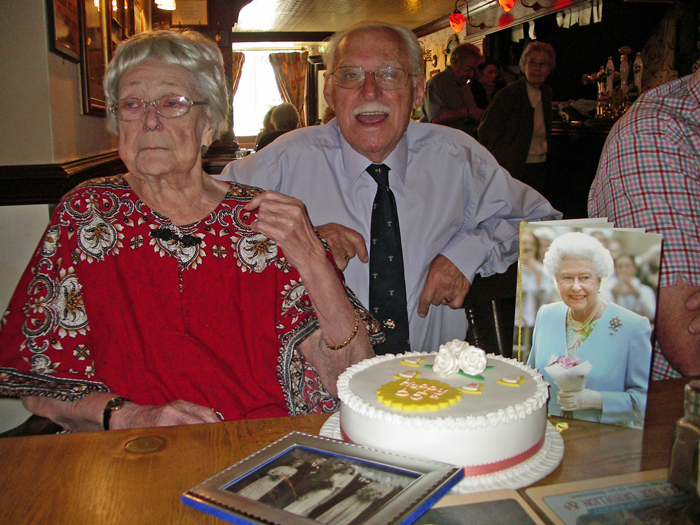 This photograph shows SSRA President Peter Martin and his wife Margaret with a beautiful 65th Wedding Anniversary Cake, and a very special card from Her Majesty The Queen.